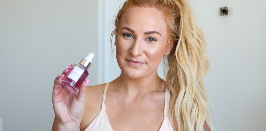 woman holding teami blends butterfly pea flower tea facial toning mist