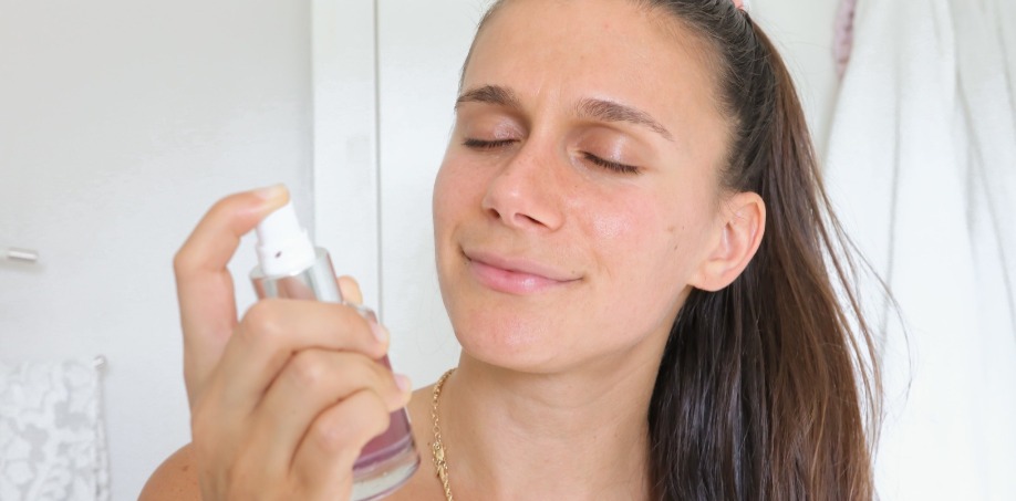 Adi spraying the butterfly toning mist on her face and neck